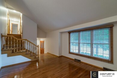 Hardwood floors, handcrafted solid oak stairs, cathedral ceilings and large front windows.
