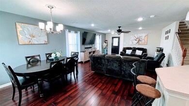 This inviting open-concept living and dining area