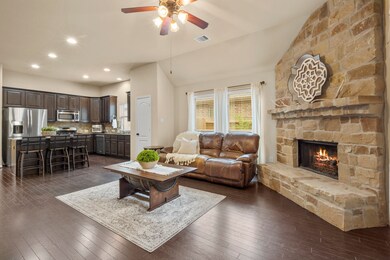 Kitchen has breakfast bar and is open to the family room