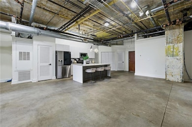 Basement with stainless steel fridge with ice dispenser