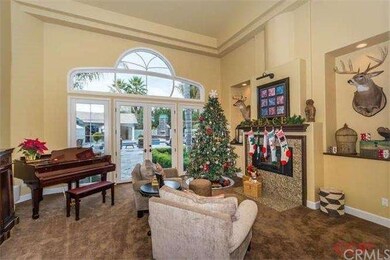 Formal living room with gas fireplace and French d