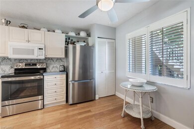 Kitchen featuring backsplash, a ceiling fan, light