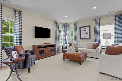 Carpeted living room with recessed lighting