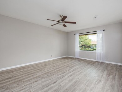 Empty room featuring ceiling fan and light wood-s