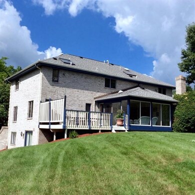 The level backyard is enclosed with trees and the 