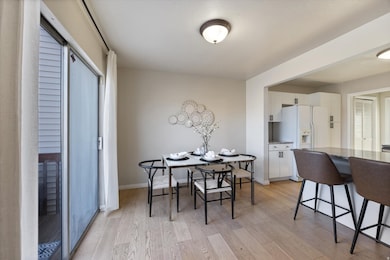 Dining space featuring light wood-type flooring and baseboards