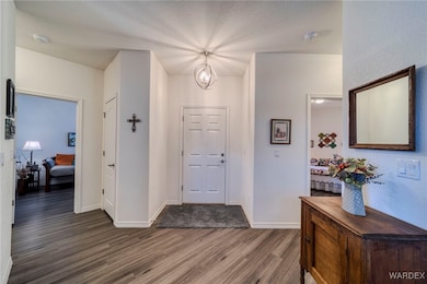 Foyer entrance featuring a notable chandelier, a t