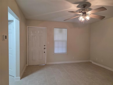 Entrance foyer featuring a ceiling fan, light til
