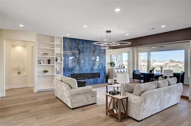 Living room with light wood-type flooring, baseboa