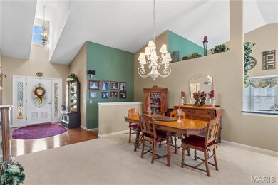 Dining space with a chandelier, carpet floors, high vaulted ceiling, and plenty of natural light