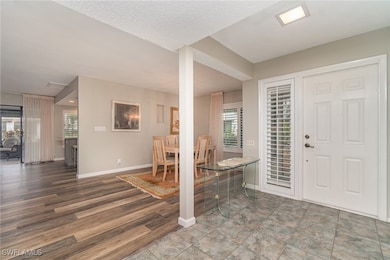 Foyer featuring baseboards and wood finished floor