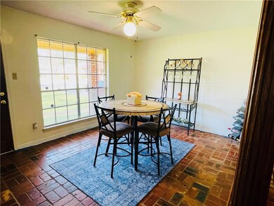 Dining space with brick floor, a ceiling fan, and 