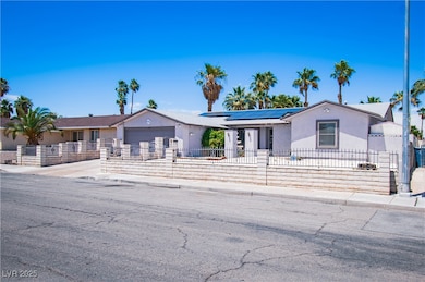 Single story home featuring a fenced front yard, a