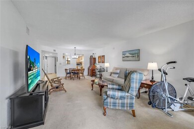 Carpeted living room featuring a textured ceiling 