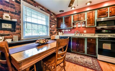 Eat in Kitchen with hardwood floors and exposed br