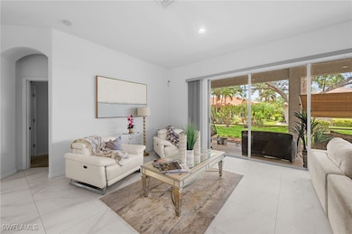 Living area featuring arched walkways and recessed