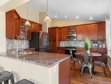 Updated kitchen with granite countertops, custom cherry wood cabinets