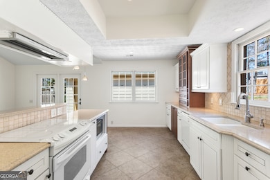 Kitchen with KraftMaid cabinetry, solid surface co