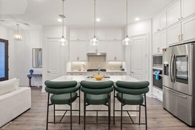 Kitchen with light wood-type flooring, appliances 