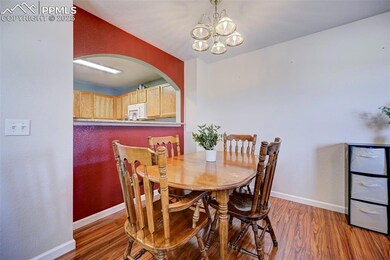 Dining room with wood-type flooring and an invitin