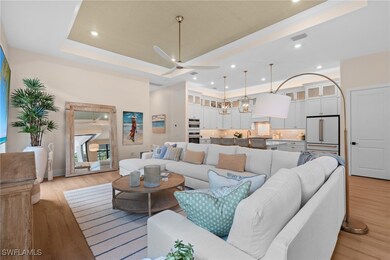 Living area featuring visible vents, ceiling fan,
