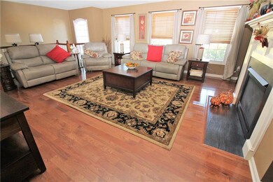 SPACIOUS living roo with gleaming hardwood floors,