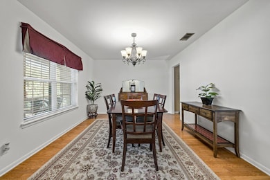 Dining room with a chandelier and light wood-type flooring