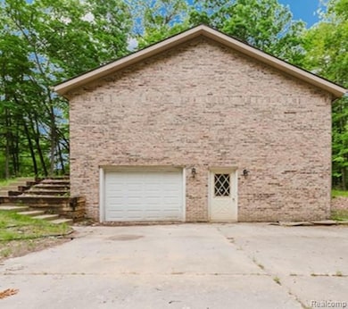 View of side of property with brick siding and driveway