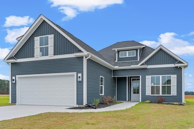 Craftsman house featuring a garage and a front law