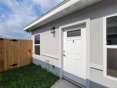 Entrance to property featuring stucco siding and fence
