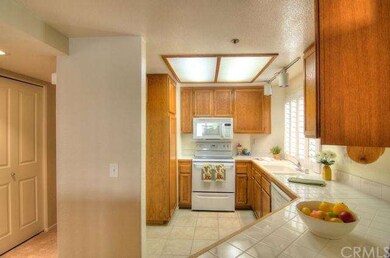 Great wood cabinetry and bright white tile counter