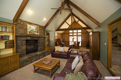 Great room has cathedral beamed ceiling, stone fir