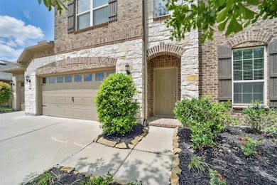 Brick and stone facade with mature landscaping.