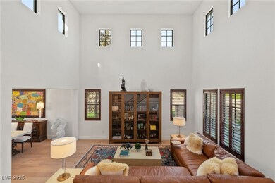 Great room with soaring ceilings, wood flooring an