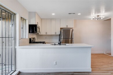 Kitchen with light countertops, visible vents, a p