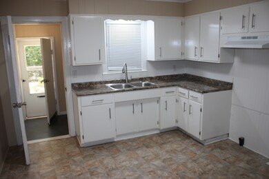 Refurbished kitchen with new sink, countertops, hood, vinyl flooring & new water lines throughout home
