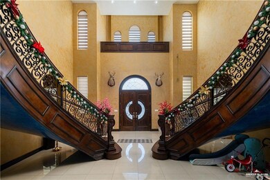 Tiled entryway featuring a towering ceiling