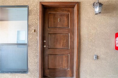 Property entrance featuring stucco siding