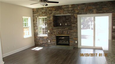 Great Room with a beautiful stone fireplace and TV