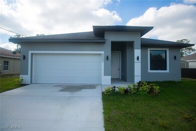 View of front facade with concrete driveway, an at