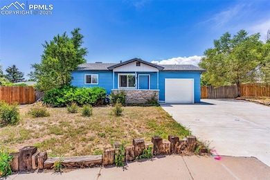 Ranch-style home featuring a garage, concrete driveway, and roof with shingles