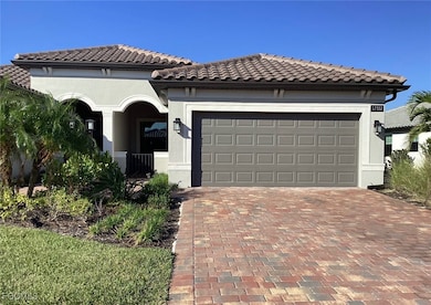 Mediterranean / spanish-style home featuring decorative driveway, stucco siding, and a tile roof