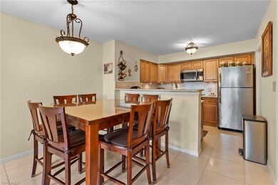 Dining area with a textured ceiling, light tile pa