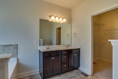 Double sink with raised vanity in Owners Bedroom.  That is the Owners closet on the right