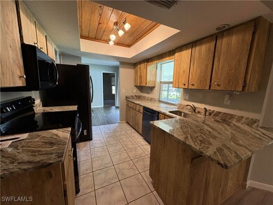 Kitchen with light tile patterned floors, sink, bl