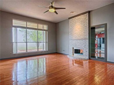 Living Room. Gleaming hardwood floors reflect the 