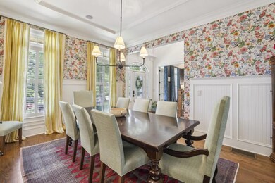Formal Dining Room with Wainscoting and Oversized Windows adds elegance for entertaining.