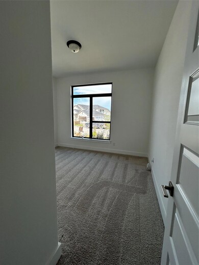 Carpeted spare room with baseboards