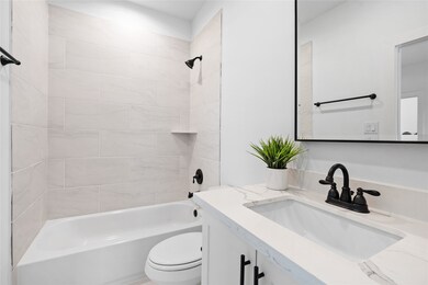 The attached ensuite bathroom features sleek finis