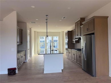 Kitchen featuring visible vents, gas stovetop, sta
